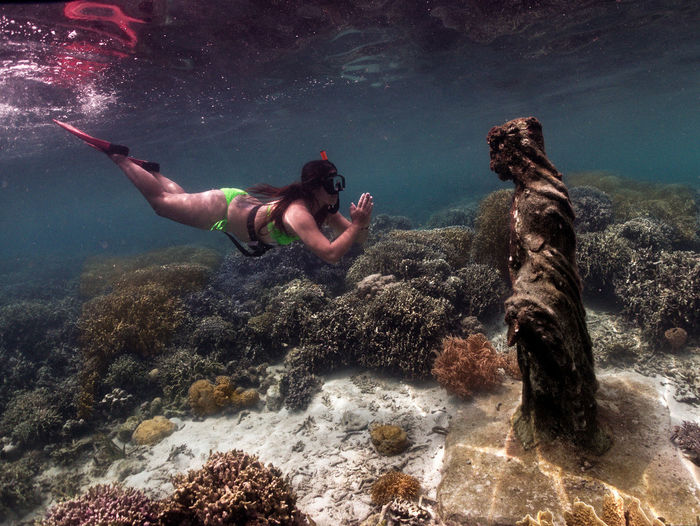Praying to mother mary beneath the waves