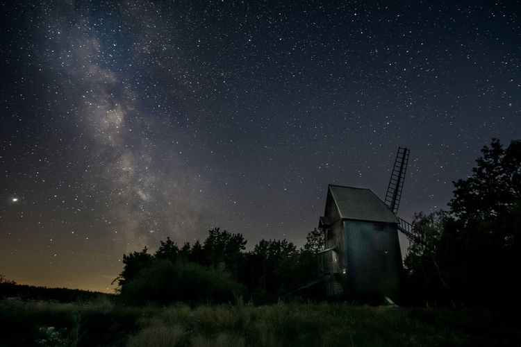 Low angle view of built structure against star field