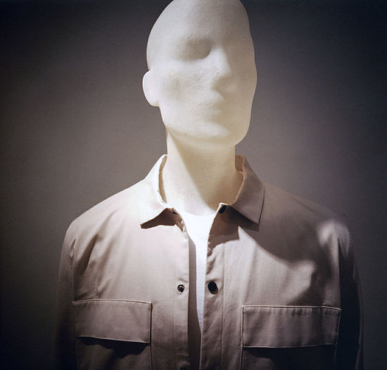 Mannequin with clothing against gray background
