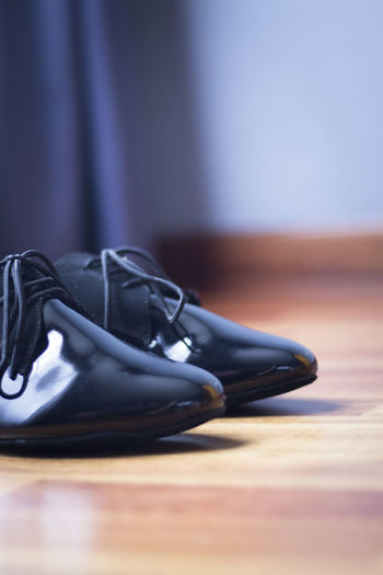 Close-up of shoes on hardwood floor