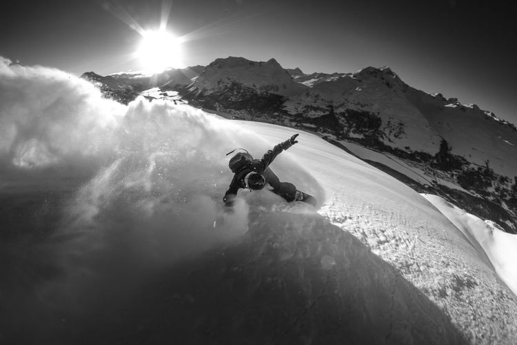 High angle view of a man snowboarding on the top of a mountain