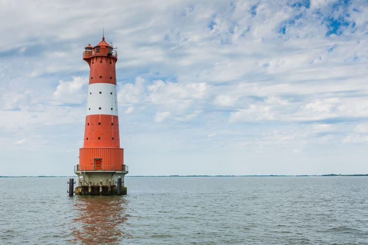 Lighthouse by sea against sky, north sera, germany