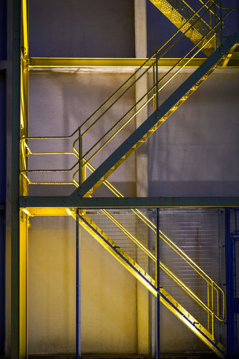 Illuminated staircase of building at night