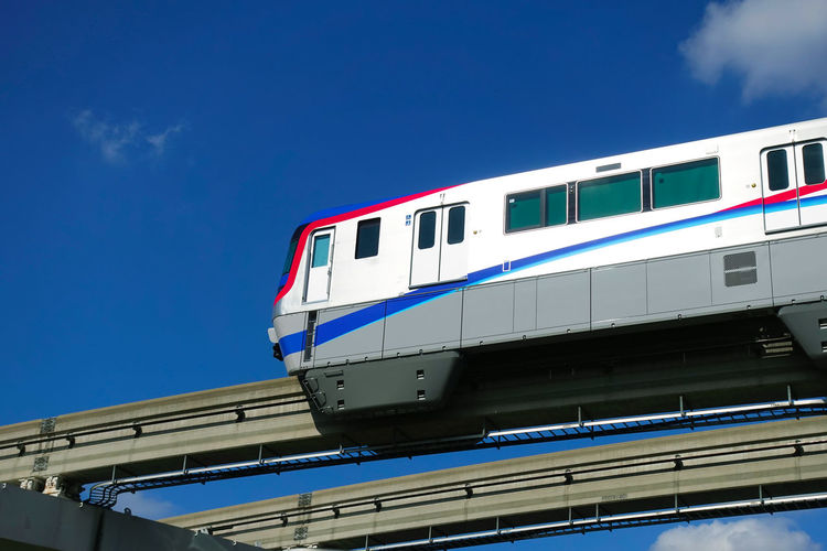 Low angle view of train against blue sky