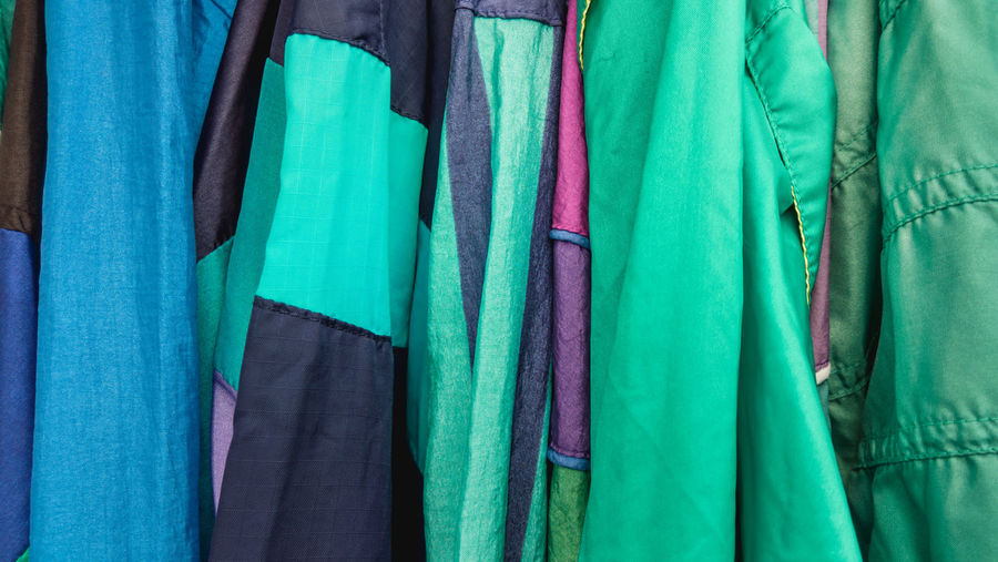 Full frame shot of multi colored clothes hanging in store for sale