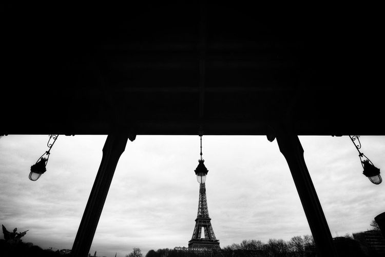 Low angle view of silhouette of the eiffel tower against sky