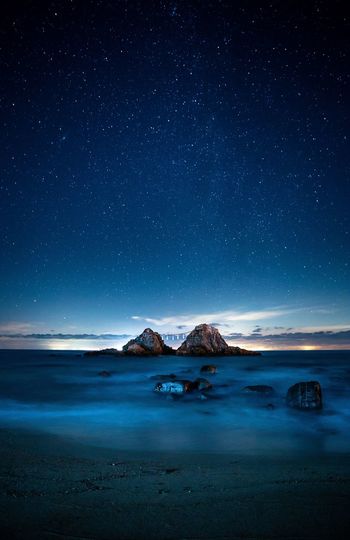 SCENIC VIEW OF SEA AGAINST STAR FIELD AGAINST SKY