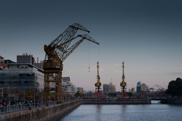 Cranes by built structure against sky in puerto madero 