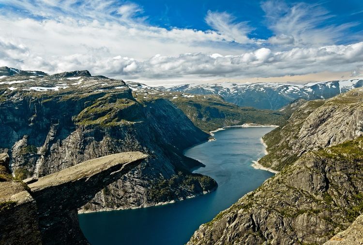 High view of trolltunga with snow capped mountains