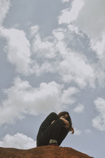 Low angle view of woman against sky