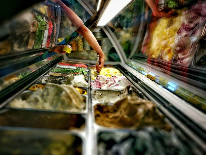 Person holding ice cream in store