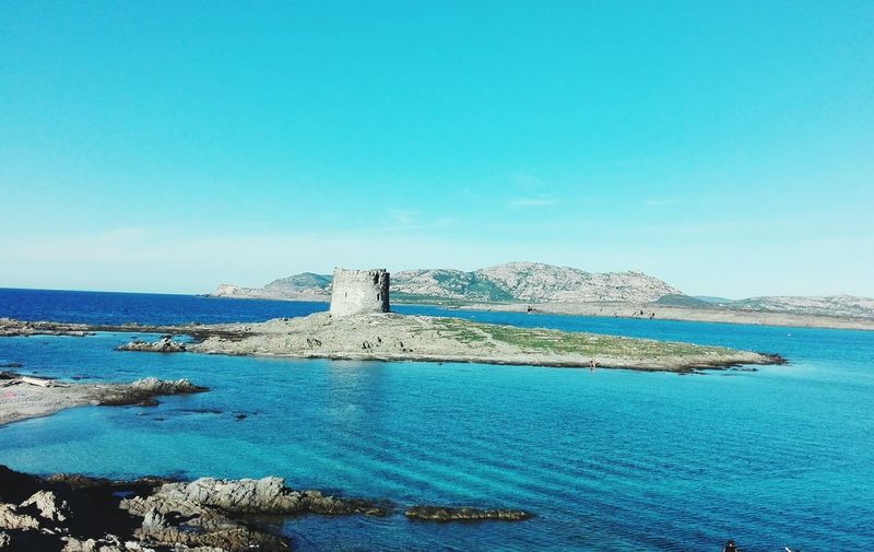 Scenic view of sea against clear blue sky