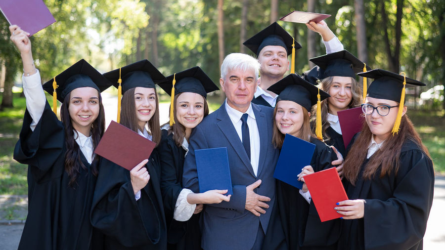 Friends wearing graduation