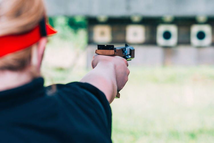 Close-up of woman aiming gun 