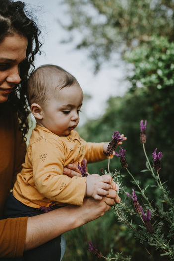 Woman with son looking at flowers