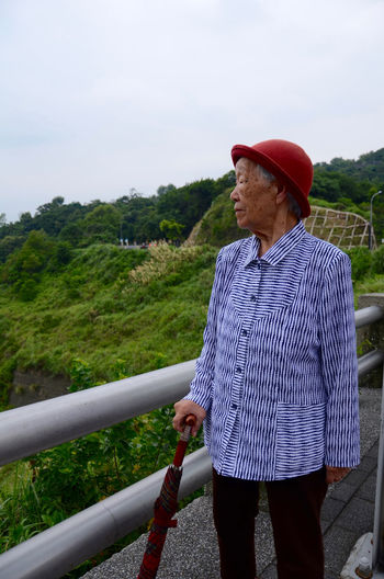 Old woman looking at mountain view