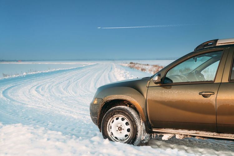 Vehicle parked on snow covered land