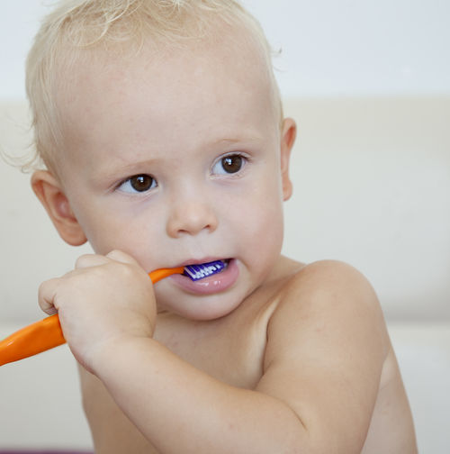 Cute toddler boy brushing his teeth.