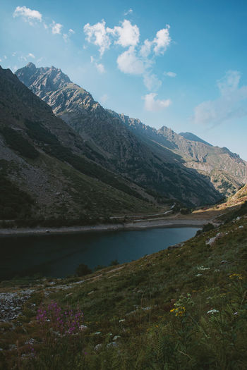 Scenic view of lake and mountains against sky