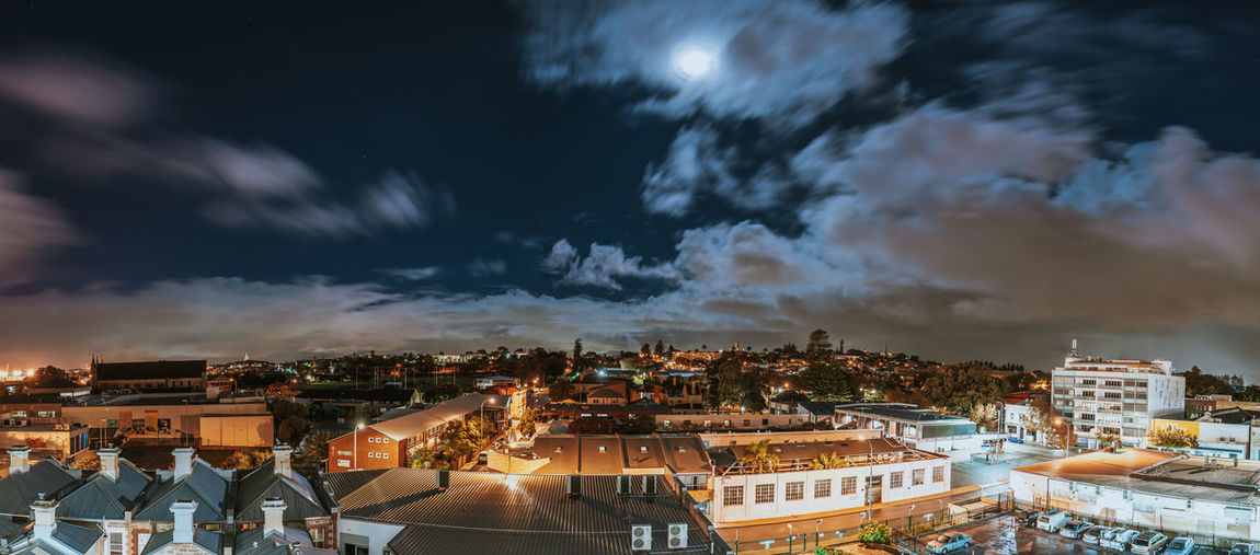 High angle shot of illuminated cityscape against sky
