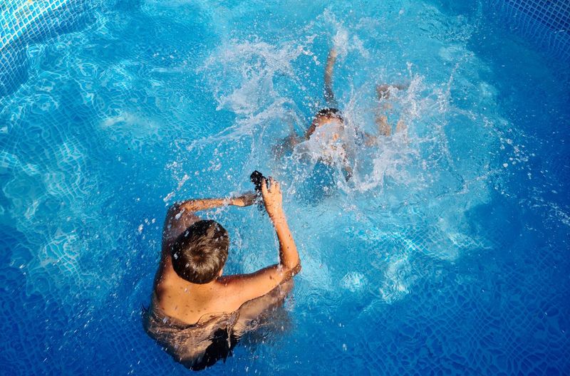 High angle view of man swimming in pool