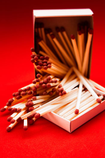 High angle view of pencil on table against red background