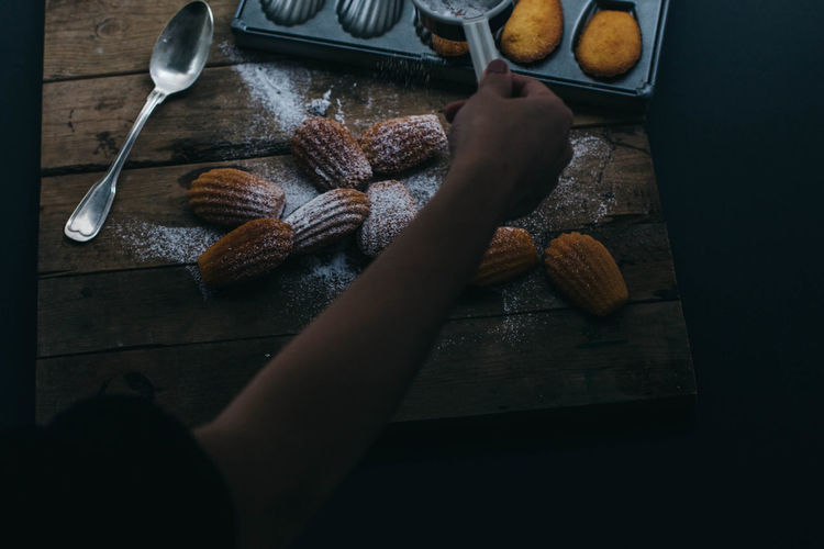 Cropped image of person making dessert