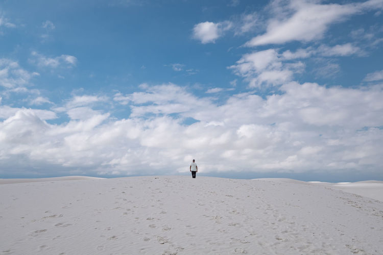 Full length of man standing on desert against sky