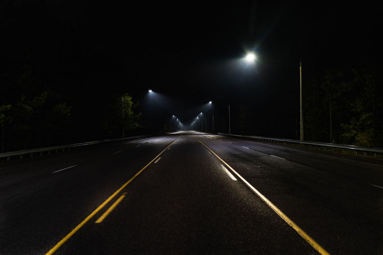 Street light trails on road at night