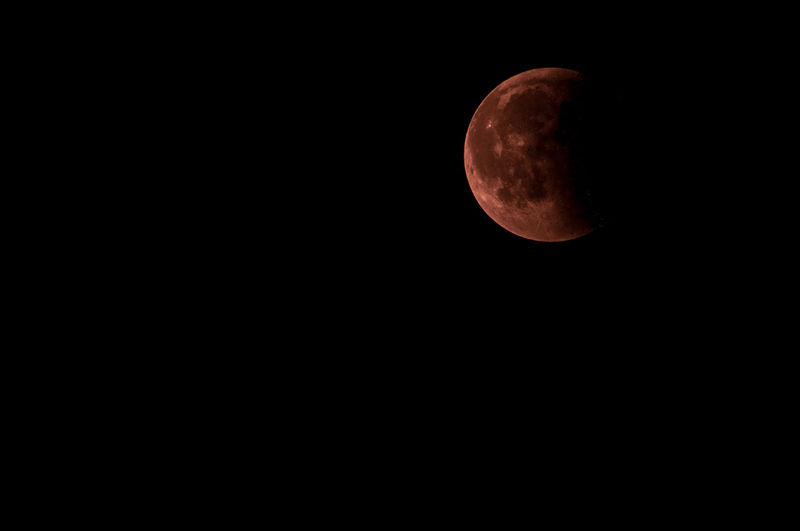 Low angle view of moon against sky at night