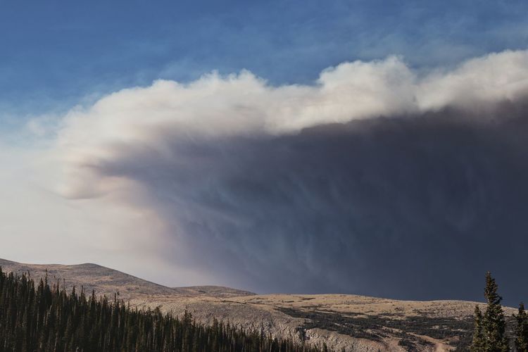 Smoke from recent wildfires roll over the hills into the colorado mountains