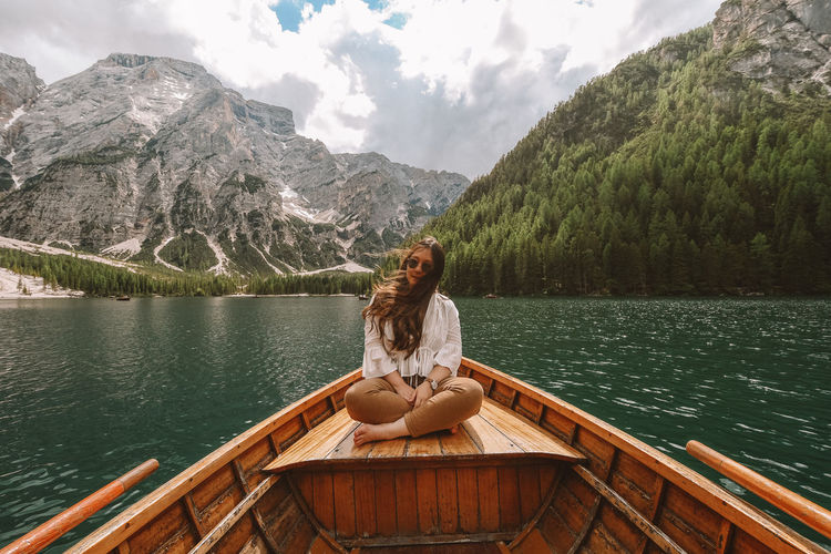 Woman sitting on boat at lake 