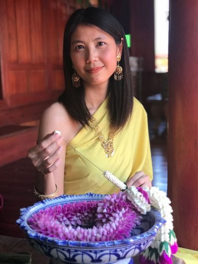 Portrait of woman making garlands