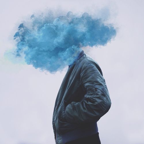 Digital composite image of smoke exploding on man face