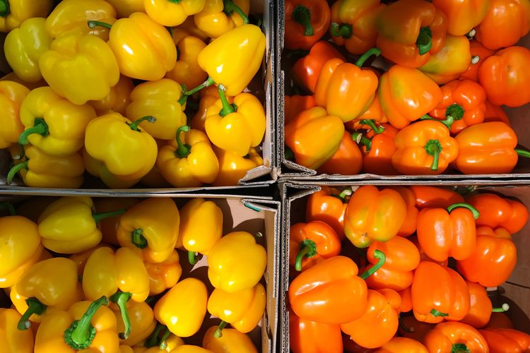 Directly above shot of yellow and orange bell pepper for sale