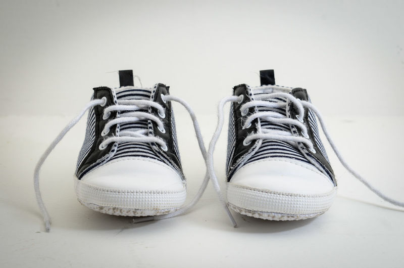 Close-up of shoes on floor against white background