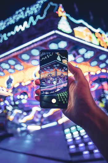 LOW SECTION OF PERSON PHOTOGRAPHING SMART PHONE ON MOBILE