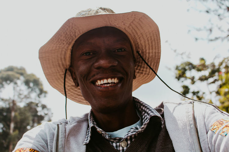 Portrait of smiling man wearing hat outdoors