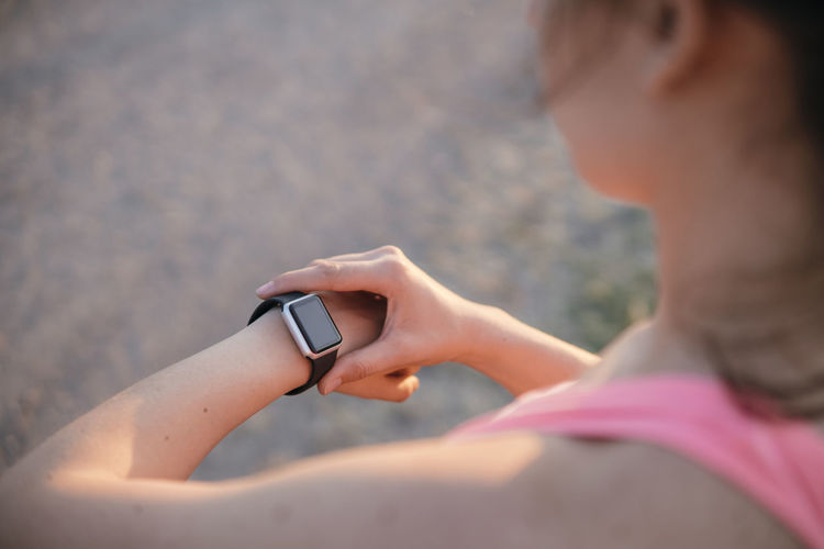 Fit young athlete checking tome on smart watch