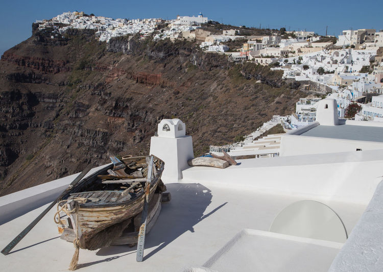 Old boat on building terrace at oia