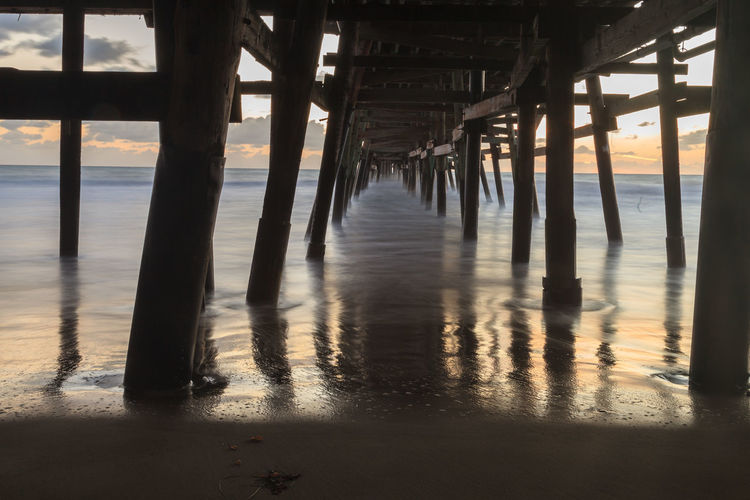 Low angle view of bridge at calm sea