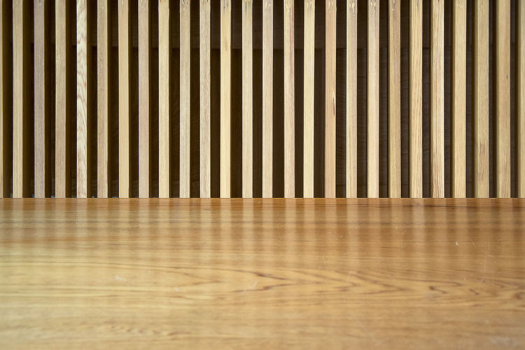 Close-up of hardwood floor by wall