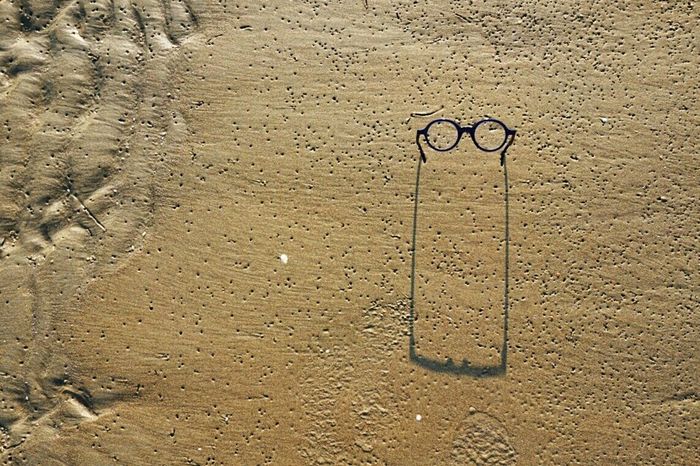 Glasses stuck in wet sand