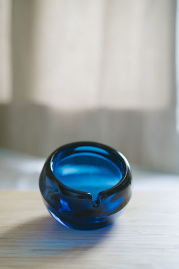 Close-up of blue glass on table