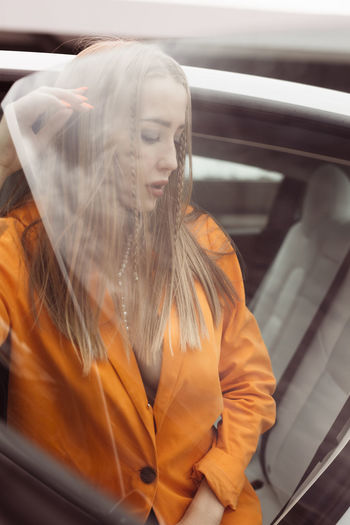 Close-up of young woman in car