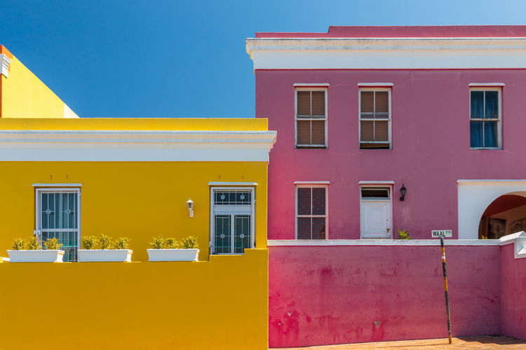 Colorful facades of old houses in yellow and pink, bo kaap malay quarter, cape town, south africa