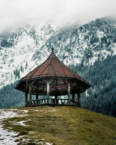 Low angle view of gazebo on hill during winter