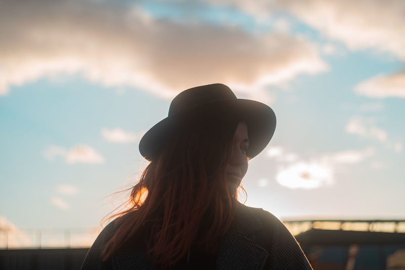 Close-up of woman against sky during sunset