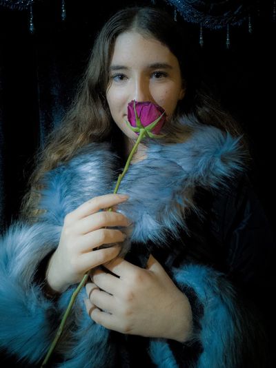 Portrait of girl holding rose