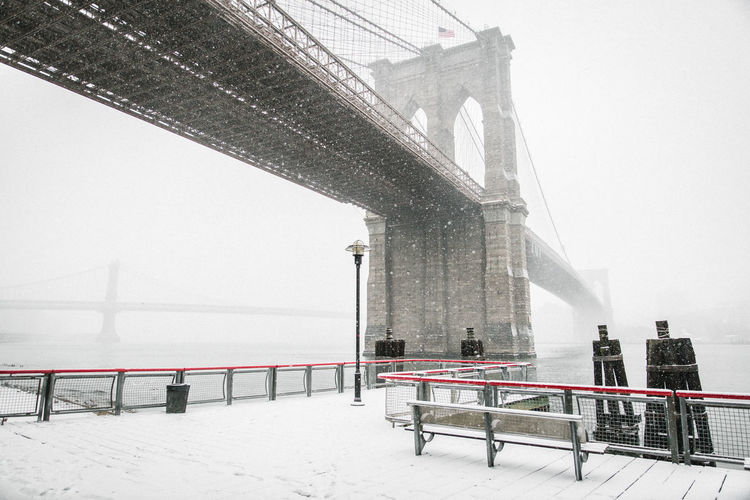 Low angle view of brooklyn bridge in winter